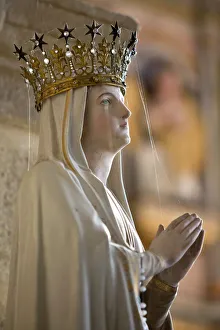 Statue of Virgin Mary wearing crown inside parish church, Saint-Thegonnec, Finistere Statue of Virgin Mary wearing crown inside parish church, Saint-Thegonnec, Finistere