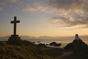 Prints of Stone Cross and old lighthouse (Twr Mawr) in silhouette at sunset on rocky tip of Llanddwyn Island National Nature Reserve, Newborough, Anglesey, North Wales, United Kingdom, Europe Related Image Prints: Llanddwyn Island Landscape Print at Sunset