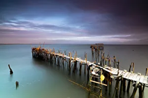 Sunrise and clouds on the Palafito Pier in the Carrasqueira Natural Reserve of Sado River Sunrise and clouds on the Palafito Pier in the Carrasqueira Natural Reserve of Sado River