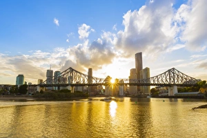 Sunset, Brisbane city with the sun hidden behind the Story Bridge, Brisbane, Queensland Sunset, Brisbane city with the sun hidden behind the Story Bridge, Brisbane, Queensland