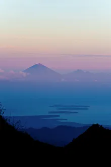 Sunset over Mount Agung and Mount Batur on Bali, and the Three Gili Isles taken from Mount Rinjani, Lombok, Indonesia Sunset over Mount Agung and Mount Batur on Bali, and the Three Gili Isles taken from Mount Rinjani, Lombok, Indonesia