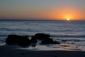 California Coastline Images Prints: Sunset over the ocean, with rocks in the foreground