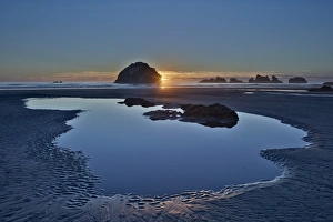 American Nature Scene Prints: Sunset by a sea stack over a pool on the beach