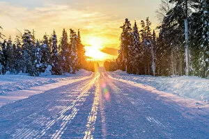 Images Dated 14th November 2022: Sunset over an empty snowy road, Lapland, Finland