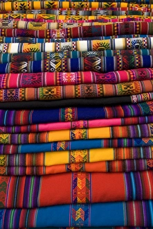Textiles for sale in the market in the village of Pisac, The Sacred Valley Textiles for sale in the market in the village of Pisac, The Sacred Valley