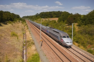 A TGV train speeds through the French countryside near to Tours, Indre-et-Loire, Centre, France, Europe A TGV train speeds through the French countryside near to Tours, Indre-et-Loire, Centre, France, Europe
