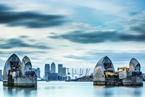 Thames Barrier on River Thames and Canary Wharf in the background, London, England Thames Barrier on River Thames and Canary Wharf in the background, London, England