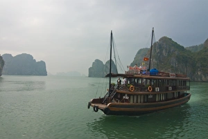 Tourist boat in a traditional style cruising the Halong Bay, Vietnam, Indochina Tourist boat in a traditional style cruising the Halong Bay, Vietnam, Indochina