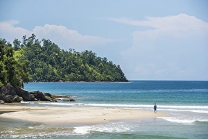 Tourist walking on Sungai Pinang Beach, near Padang in West Sumatra, Indonesia, Southeast Asia Tourist walking on Sungai Pinang Beach, near Padang in West Sumatra, Indonesia, Southeast Asia