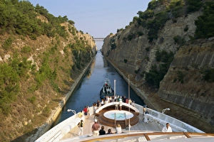 Corinth Canal Greece Prints: Tourists on the bow of a ship being pulled by tug through