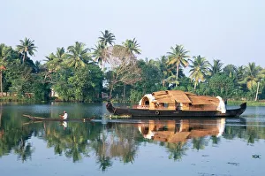 Tourists rice boat on the backwaters near Kayamkulam Tourists rice boat on the backwaters near Kayamkulam