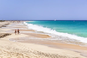 Tourists walking along the sandy beach, Ponta Preta beach, Santa Maria, Sal Island Tourists walking along the sandy beach, Ponta Preta beach, Santa Maria, Sal Island