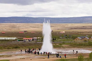 Tourists watching Strokkur Geyser erupting, Geysir, Iceland, Polar Regions Tourists watching Strokkur Geyser erupting, Geysir, Iceland, Polar Regions