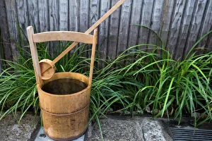 Traditional Japanese wooden bucket and ladle for washing sidewalk in a custom called uchimizu Traditional Japanese wooden bucket and ladle for washing sidewalk in a custom called uchimizu