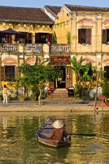 Traditionally dressed old man sitting in his little fishing boat, Hoi An Traditionally dressed old man sitting in his little fishing boat, Hoi An