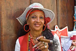 Typical dressed Cuban woman smoking a giant cigar, Havana, Cuba, West Indies Typical dressed Cuban woman smoking a giant cigar, Havana, Cuba, West Indies