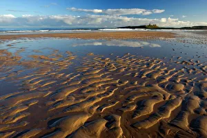 View across Embleton Bay at low tide towards the ruins of Dunstanburgh Castle View across Embleton Bay at low tide towards the ruins of Dunstanburgh Castle