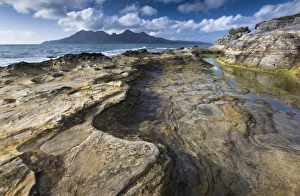 View towards Isle of Rum from rock formations at Laig Bay, Isle of Eigg View towards Isle of Rum from rock formations at Laig Bay, Isle of Eigg