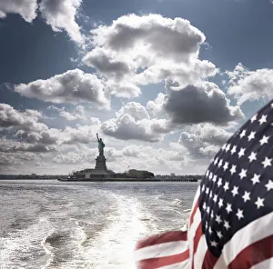 View of Statue of Liberty from rear of bot with Stars and Stripes flag View of Statue of Liberty from rear of bot with Stars and Stripes flag
