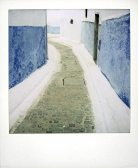 View taken on Polaroid down narrow street showing traditional View taken on Polaroid down narrow street showing traditional