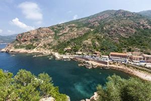 Top view of turquoise sea framed by green vegetation and the typical village of Porto Top view of turquoise sea framed by green vegetation and the typical village of Porto