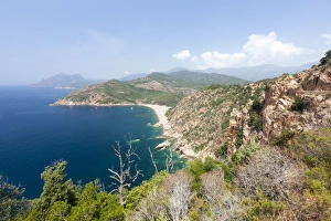 Top view of turquoise sea and sandy beach framed by green vegetation on the promontory Top view of turquoise sea and sandy beach framed by green vegetation on the promontory