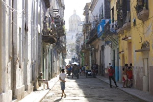 View along a typical residential street in Havana Vieja showing children playing View along a typical residential street in Havana Vieja showing children playing