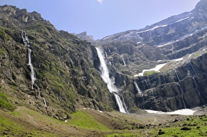 Waterfalls cascade down the karst limestone cliffs of the Cirque de Gavarnie, Pyrenees National Park, Hautes-Pyrenees Waterfalls cascade down the karst limestone cliffs of the Cirque de Gavarnie, Pyrenees National Park, Hautes-Pyrenees