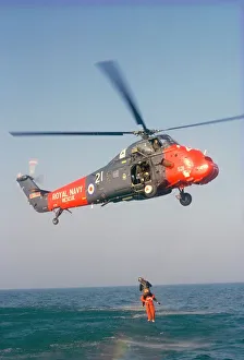 Wessex helicopter winching up survivior in rescue from sea Wessex helicopter winching up survivior in rescue from sea