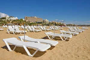 Empty white sun lounger sunbeds on Praia da Rocha beach, Portimao, Algarve Empty white sun lounger sunbeds on Praia da Rocha beach, Portimao, Algarve