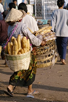 Woman carrying two baskets of French bread in the Talaat Woman carrying two baskets of French bread in the Talaat