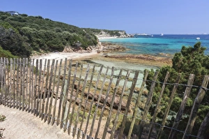 The wooden fence frames the limestone rocks and turquoise sea, Sperone, Bonifacio The wooden fence frames the limestone rocks and turquoise sea, Sperone, Bonifacio