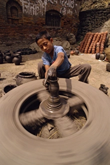 Young boy throwing a pot Print, Nepal