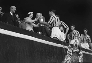 Aston Villa captain Johnny Dixon receives the FA Cup from the Queen in 1957 Aston Villa captain Johnny Dixon receives the FA Cup from the Queen in 1957