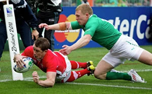 Images Dated 8th October 2011: Shane Williams evades Keith Earls to score in the 2011 World Cup quarter-final