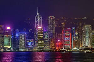 Kong Collection: Lights of the city skyline of Central across Victoria Harbour at night in Hong Kong