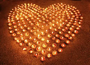 Love heart shape made out of burning candles and light Love heart shape made out of burning candles and light
