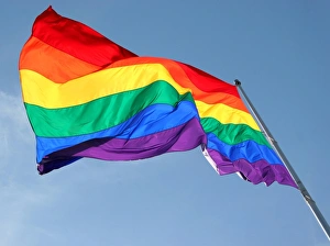 Rainbow Flag flying against blue sky - Symbol of Gay Pride Rainbow Flag flying against blue sky - Symbol of Gay Pride