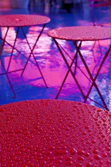 Abstract water droplets on a red table under the Neon lights of 42nd Street, Times Square Abstract water droplets on a red table under the Neon lights of 42nd Street, Times Square