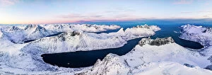 Norway Collection: Aerial panoramic view of Grytetippen mountain covered with snow overlooking the frozen Ornfjord