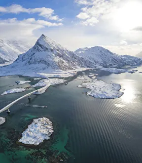 Aerial panoramic view of snowy peak of Volanstinden and Fredvang bridge, Lofoten Islands Aerial panoramic view of snowy peak of Volanstinden and Fredvang bridge, Lofoten Islands