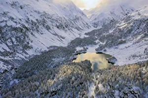 Aerial view of Lake Cavloc after an autumn snowfall, Maloja Pass, Bregaglia Valley Aerial view of Lake Cavloc after an autumn snowfall, Maloja Pass, Bregaglia Valley