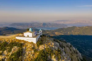 Aerial view of the Orthodox church of the Prophet Elias at sunset in summer Aerial view of the Orthodox church of the Prophet Elias at sunset in summer