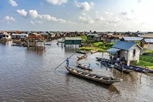 Africa, Benin, Ganvie. a scene on the main channel with boats, shops and stilt houses Africa, Benin, Ganvie. a scene on the main channel with boats, shops and stilt houses