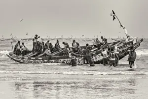 Africa, Senegal, Kayar. Fishermen with their boat going out Africa, Senegal, Kayar. Fishermen with their boat going out