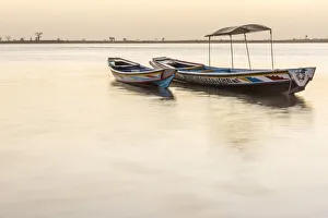 Africa, Senegal, Sine-Saloum-Delta. Fishing boats at sunrise Africa, Senegal, Sine-Saloum-Delta. Fishing boats at sunrise