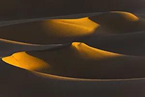 Algeria, Sahara, Last rays of sun on a group of dunes Algeria, Sahara, Last rays of sun on a group of dunes