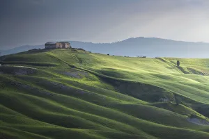 A barn and the rolling hills, Crete Senesi, Tuscany, Italy A barn and the rolling hills, Crete Senesi, Tuscany, Italy