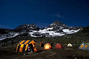 Camping under the full moon, night shot of Mount Kilimanajro with tents Camping under the full moon, night shot of Mount Kilimanajro with tents