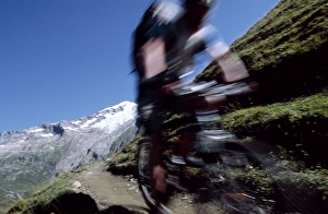 A cyclist mountain biking on Mont Blanc A cyclist mountain biking on Mont Blanc